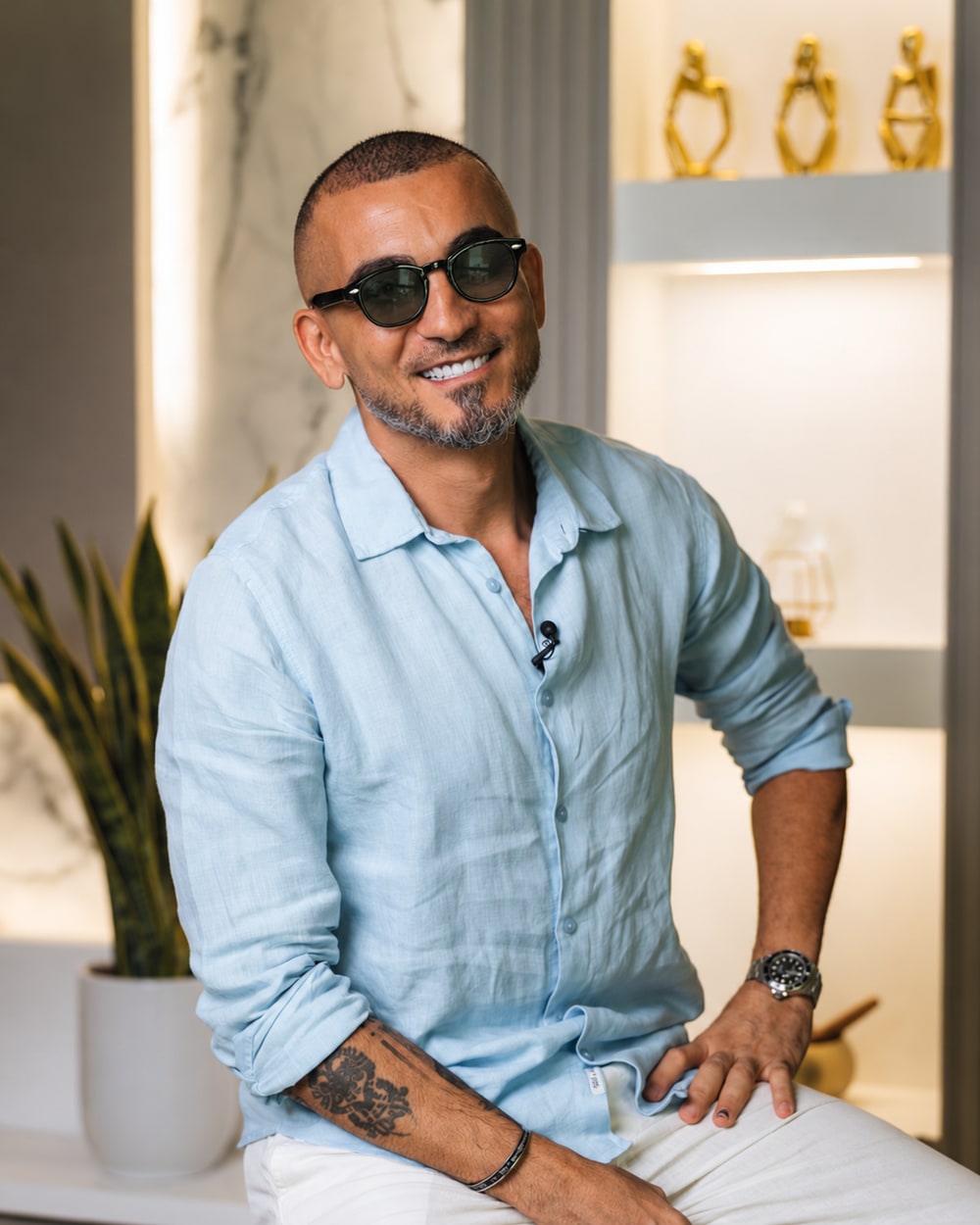 Carlos Misk smiling in a light blue shirt
